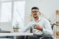 Positive disabled young man in wheelchair working in office Royalty Free Stock Photo