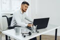 Positive disabled young man in wheelchair working in office Royalty Free Stock Photo