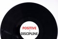 Positive discipline symbol. Concept words Positive discipline on beautiful black vinyl disk. Beautiful white table white