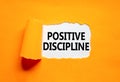Positive discipline symbol. Concept words Positive discipline on beautiful white paper. Beautiful orange paper background.