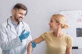 positive doctor in latex gloves vaccinating