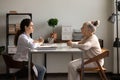 Positive doctor and old patient meeting and talking in office Royalty Free Stock Photo