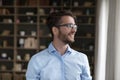 Positive dreamy handsome young business man in trendy eyeglasses Royalty Free Stock Photo