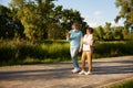 Positive elderly couple with refreshment cocktail walking outdoors