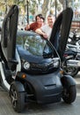 Couple standing near twizy electric