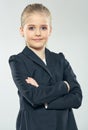 Positive emotional little business woman posing on isolated gra Royalty Free Stock Photo