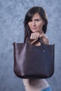 Positive emotional portrait of young and pretty girl with bag Royalty Free Stock Photo