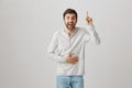 Positive emotions and advertising concept. Good-looking guy in casual clothes laughing, holding his belly while pointing