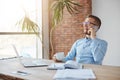 Positive emotions. Business concept. Cheerful professional adult caucasian finance manager in glasses and blue shirt Royalty Free Stock Photo