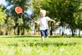 Cheerful little boy running in the park