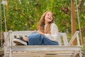 positive emotions. glad child on swing. kid swinging outdoor. teen girl having fun Royalty Free Stock Photo