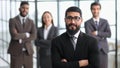 positive employee posing for company business catalogue with colleagues at background