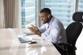 Positive employee with wireless earphone talking to customer