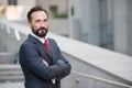 Positive entrepreneur looking away with arms crossed