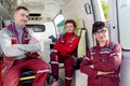 Positive ER Doctor with Paramedics Colleagues in Ambulance Car Royalty Free Stock Photo