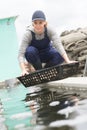 positive european fish farm employee nursing seashells