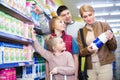 Positive family of four buying pasteurized milk Royalty Free Stock Photo