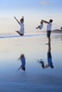 Positive family having fun on black sand sea beach Royalty Free Stock Photo