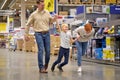 Positive family having fun while choosing things in supermarket Royalty Free Stock Photo