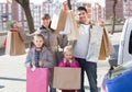 Positive family portrait with purchases in bags Royalty Free Stock Photo