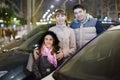 Positive family of three standing near car Royalty Free Stock Photo