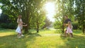 Positive family throwing frisbee disk in park. Smiling girl catching frisbee plate. Young parents playing frisbee with Royalty Free Stock Photo