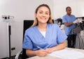 Positive female doctor cosmetologist filling medical forms Royalty Free Stock Photo