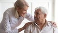 Positive female nurse taking care of senior male patient