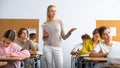 Female teacher giving lesson to children in school Royalty Free Stock Photo