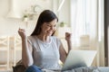 Young woman happy about good news received by email