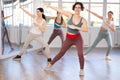 Positive females funk jazz dancers exercising dance moves in studio