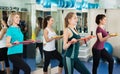 Positive females working out on aerobic step platform Royalty Free Stock Photo