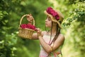 Positive florist holding flowerpot. flower composition. Beautiful girl in straw hat collect roses. happy childhood