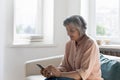 Positive focused senior woman typing on mobile phone Royalty Free Stock Photo