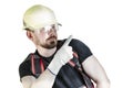 Positive friendly bearded male builder in overalls, hardhat and goggles pointing with his finger. Isolated background Royalty Free Stock Photo