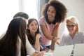 Positive friendly diverse team employees talking laughing at company meeting