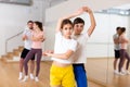 Teen sister and brother learning to dance waltz in pair in studio Royalty Free Stock Photo