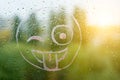 Positive funny smiley on rainy autumn window Royalty Free Stock Photo