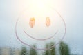 Positive funny smiley on rainy autumn window Royalty Free Stock Photo