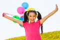 Positive girl with arms up and balloons in air Royalty Free Stock Photo