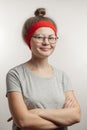 Positive girl with hairbun keeping arms crossed Royalty Free Stock Photo