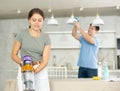 Positive girl and her husband are cleaning kitchen Royalty Free Stock Photo