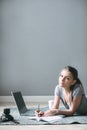 Positive girl with laptop surfing Internet, laying on the floor Royalty Free Stock Photo