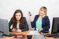 Positive girl in the office with a phone in his hand close to the negative counterpart Royalty Free Stock Photo