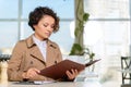 Positive girl sitting at the table Royalty Free Stock Photo