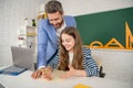 positive girl with teacher in classroom use laptop Royalty Free Stock Photo