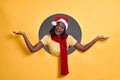 Positive glad african female wearing Christmas hat says: wow how exciting it is, has amazed expression, shows something on copy Royalty Free Stock Photo