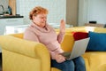 Positive grandma Smiling middle aged old woman relaxing holding laptop