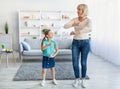 Positive grandmother dancing to music with cute little girl Royalty Free Stock Photo