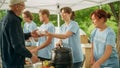 Positive Group of Young Adult Volunteers Serving Free Food for Poor People in Need. Charity Workers